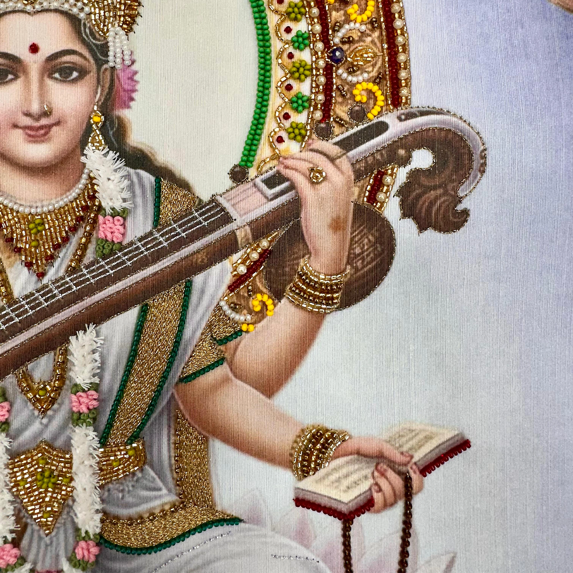 Artistic depiction of a figure holding a stringed instrument and a book, adorned with jewelry and traditional clothing.